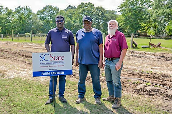 Extension staff with farmer.