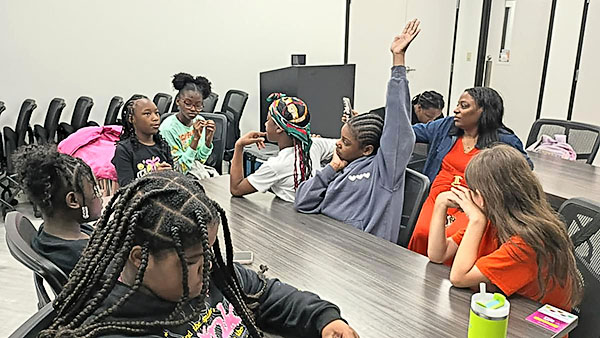 Angela Howard promotes and teaches overall health and wellness to a group of students.
