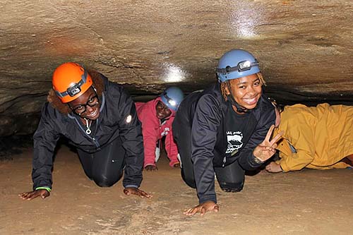 Students exploring a cave.
