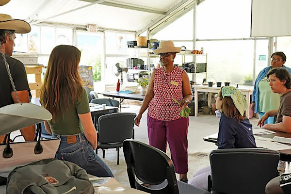 Judith Mutamba presents on the nutritious qualities of pumpkin leaves at Lincoln University’s Finca EcoFarm.