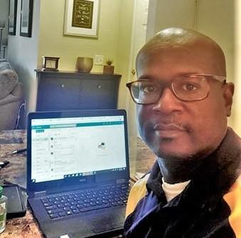 Phillip Petway, FVSU Twiggs County 4-H Extension agent, sits in front of his laptop, which he uses to provide programs to youth in his service area.