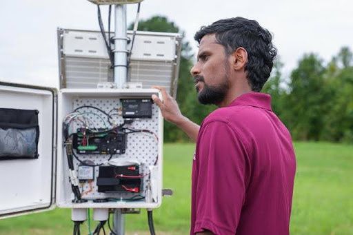 Dr. Hemanth Dakshinamurty with weather measurement system.