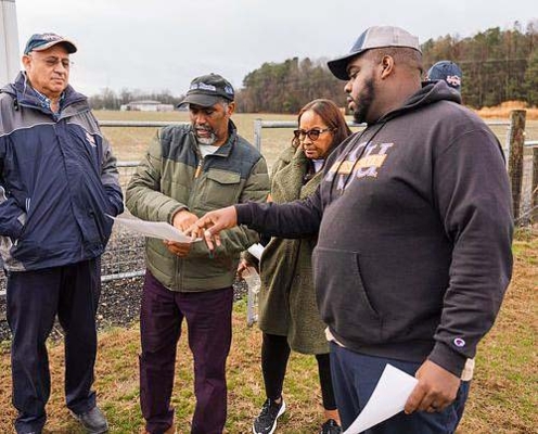 William Crutchfield, director of the Small Farm Outreach Program, and Alston Hilliard, SFOP program coordinator, consult with Black farmers on how they can best optimize their farm production.