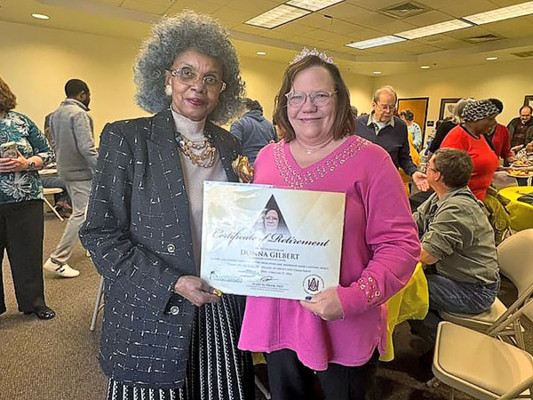 Donna Gilbert, in her tiara, with AAMU Research Coordinator Debbie Hunter.