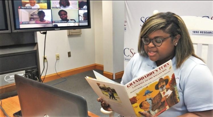 Sydney Reid, South Carolina State University 1890 Midland’s Extension agent, leads book club participants while reading "Granddaddy’s Turn" during the July 7 session.