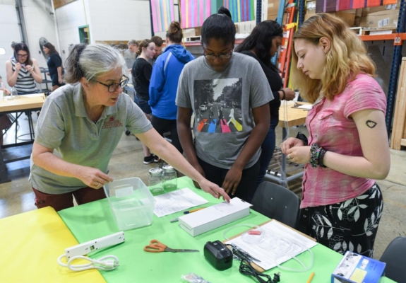 Dr. Melinda Schwarz helps students set up an experiment to grow Spirulina.