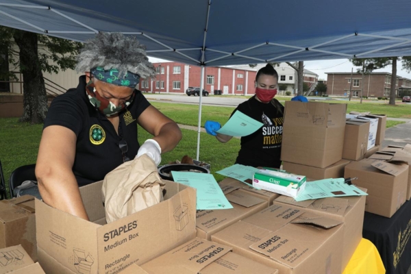Teki Hunt, director of the University of Arkansas at Pine Bluff 4-H Youth Development Program, prepares boxes of food and toiletries for distribution.