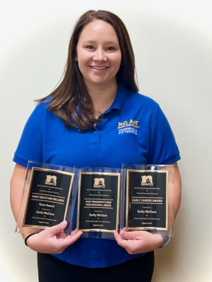 Family and consumer sciences agent Emily McClure holds three awards.