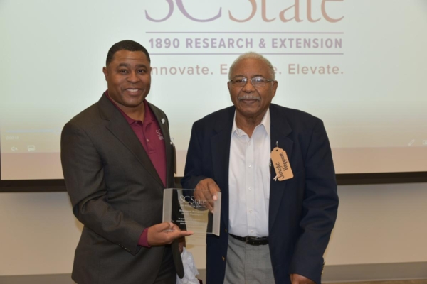 Dr. Louis Whitesides, vice president and executive director for 1890 programs, awards Ishmel Washington first ever Ishmel Washington Excellence in Extension Award.