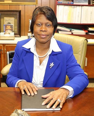 Dr. Marilyn Bailey sitting at her desk.
