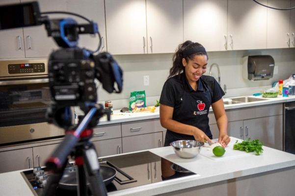 WVSU Extension Associate Kateira Hogan prepares a healthy recipe for a virtual EFNEP program with middle school students.