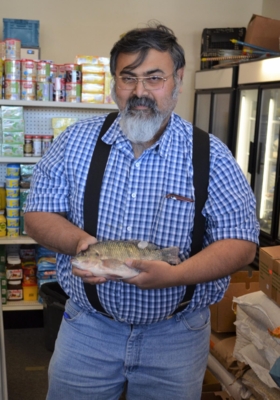 Central State University Extension Associate Director Dr. Siddhartha Dasgupta holds a fish.