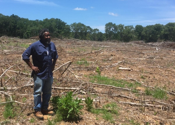 Charley Williams, veteran NRCS soil conservationist, conducts a site visit at the property of a landowner.
