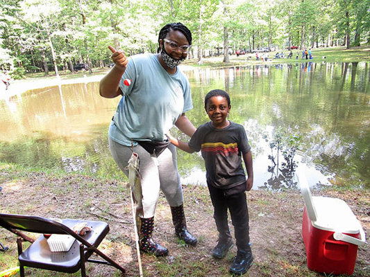 Youth participate in annual fishing derby.