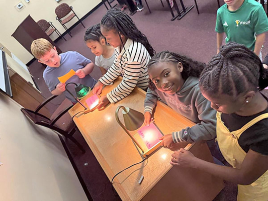 Young people engage in a hands-on activity.