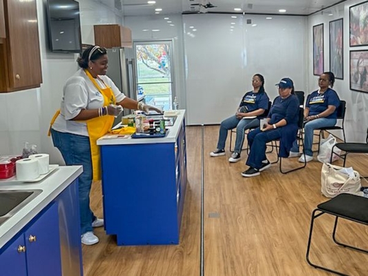 Extension specialist cooks a meal in the Mobile Health Unit.